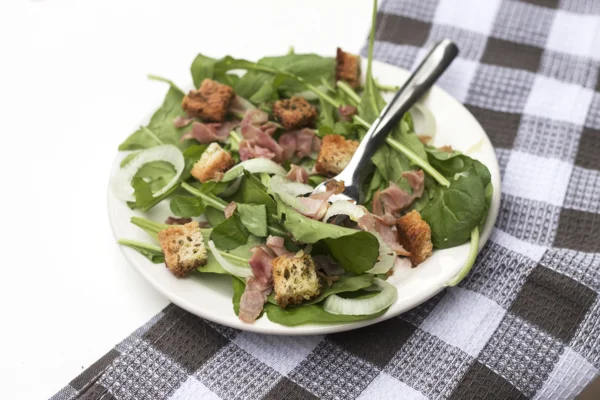 Salada de rúcula, croutons e lombo à manteiga